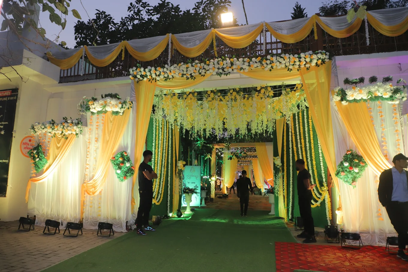 Elegant entrance with yellow and white drapes and floral decorations
